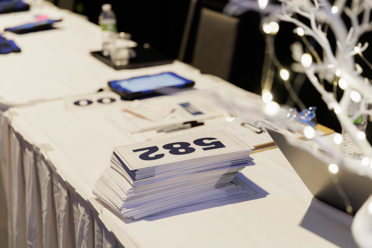 Professional benefit auctioneer calling bids at a live charity gala fundraiser