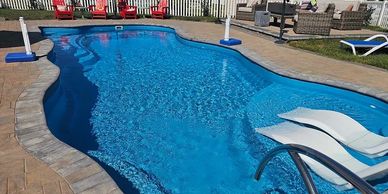 Fiberglass pool with sun ledge. Inground pool installed. Pool with sundeck. Pool with sun platform. n