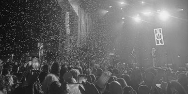 Concert with confetti and enthusiastic crowd.