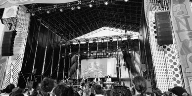 Black and white photo of a live band on stage with a crowd in front.