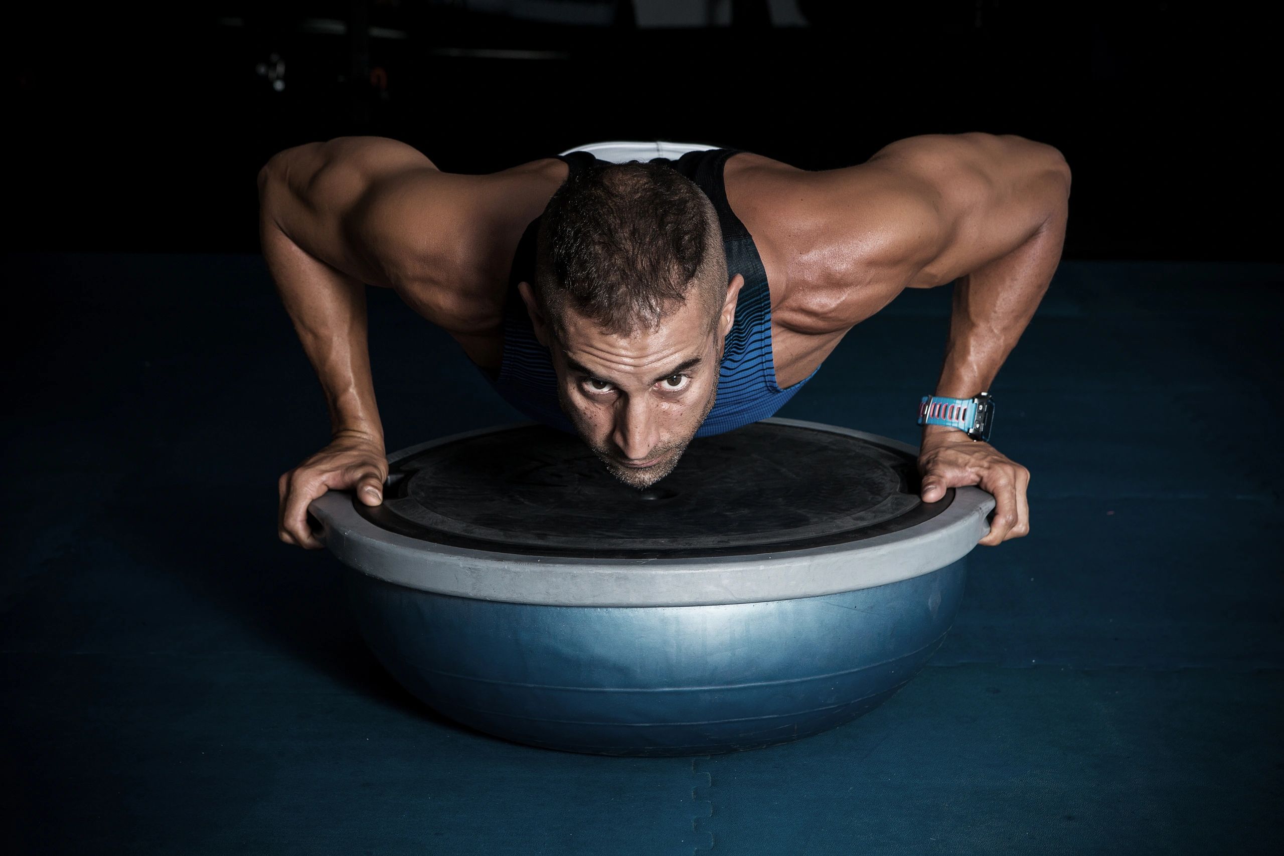 Man exercising on bosu ball