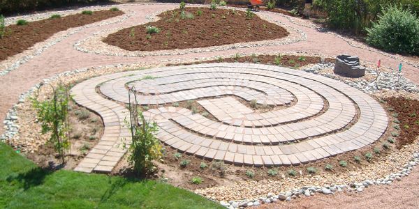 Stone labyrinth pathway in a garden under construction.