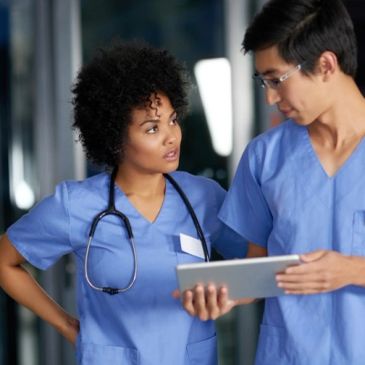 Two medical professionals discussing patient information.