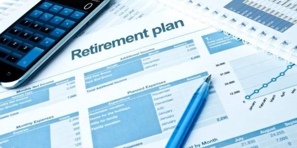 Documents and a calculator for a retirement plan.