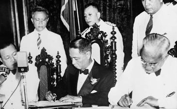 an old picture of men signing 