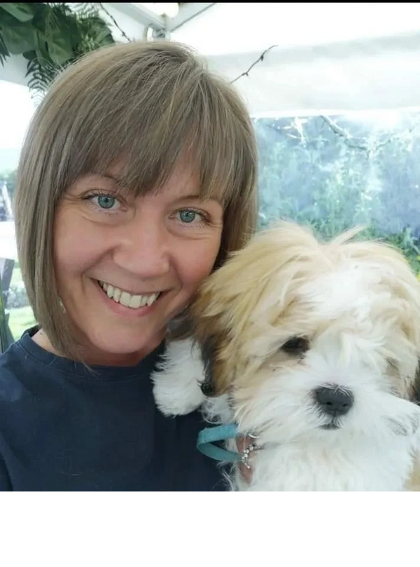 Clare, owner of Raggy Rascals holding a puppy