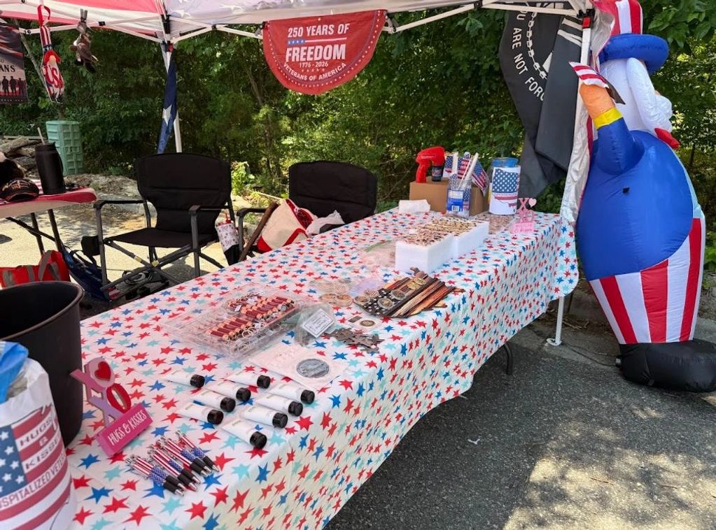 Patriotic booth with red, white, and blue decorations and merchandise.