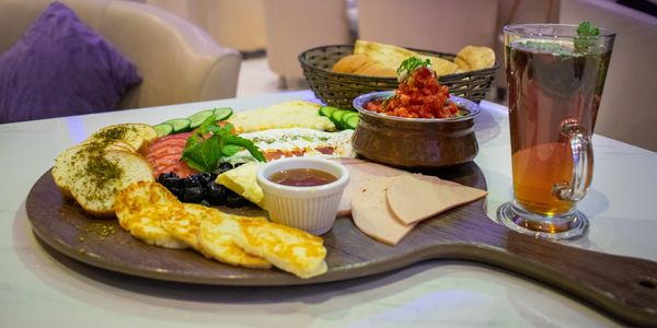 Arabic breakfast platter with tea, Arabic bread, hummus and halloumi cheese