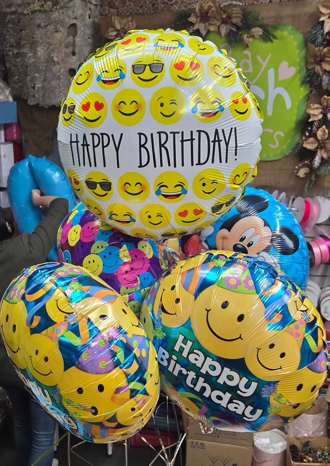 Happy birthday balloons with emoji designs.