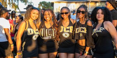 Group of five young women wearing UCF clothing and smiling.
