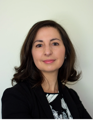 Professional headshot of a woman with dark hair.