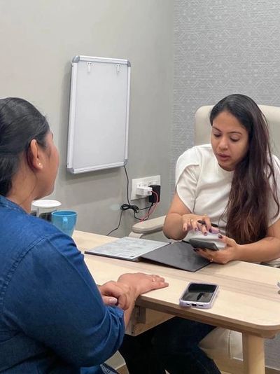 Two women having a discussion in an office setting.