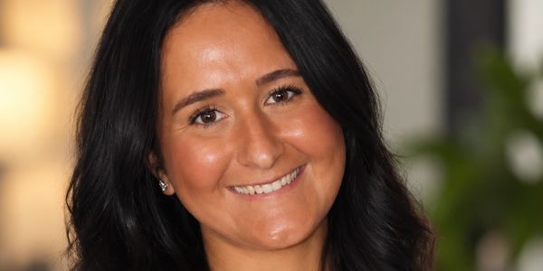 Smiling woman with dark hair.