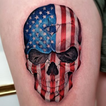 Color realism skull colored like the American Flag on thigh.