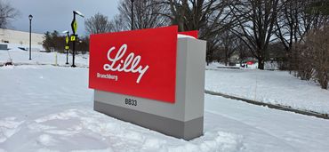 Lilly Branded sign in snowy landscape.
