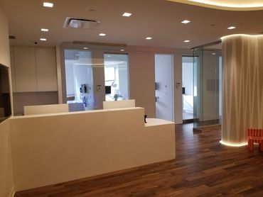 Modern dental office reception with clean design and wooden flooring.