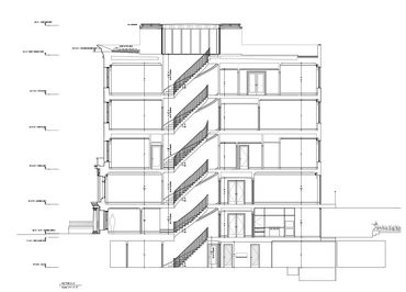 Architectural section drawing of a multi-story building with staircases and detailed floor levels.