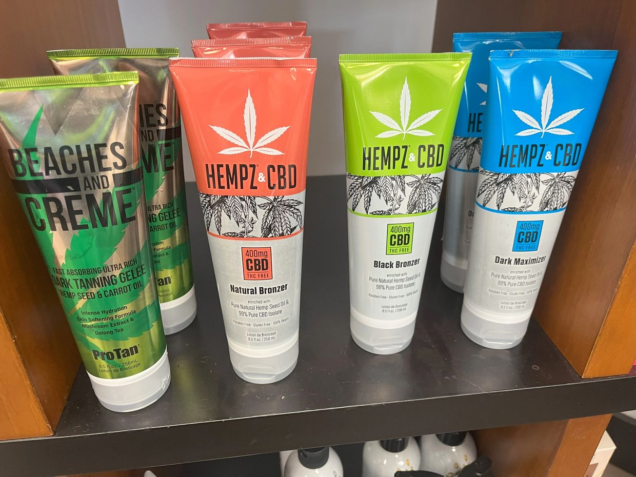 Bottles of Southwest Michigan CBD skincare and tanning lotion.