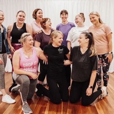 Group of ladies standing together laughing in the dance studio after dance classes.