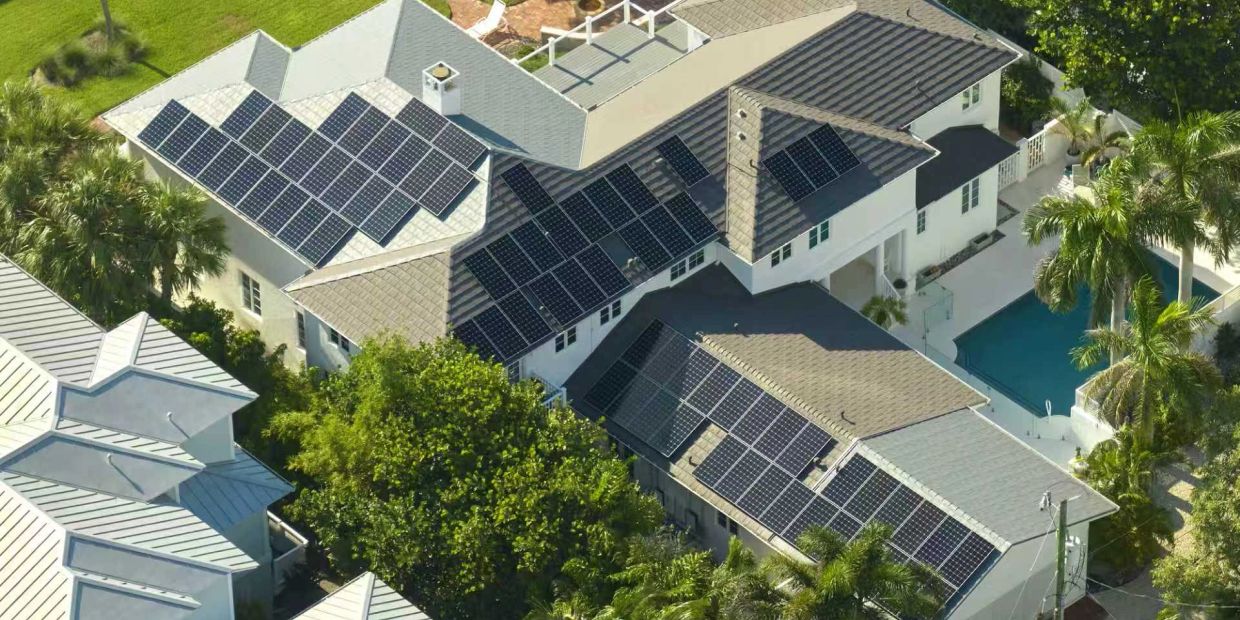 A house with multiple solar panels on the roof.