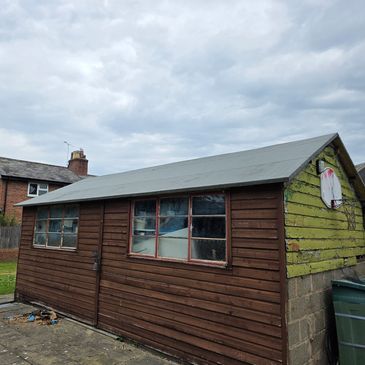 An image of a shed with new felt roofing. 
