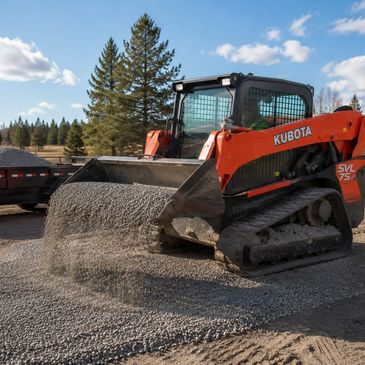 Kubota skid steer moving gravel.