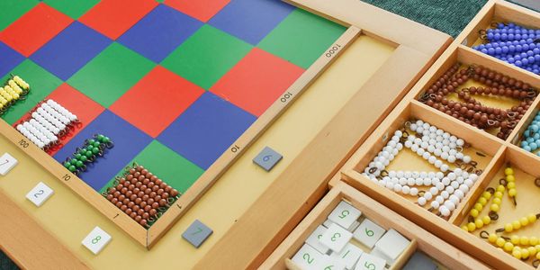 The Montessori Checkerboard board has number bead bars and number tiles. 