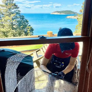 Window cleaner cleaning seaside windows.
