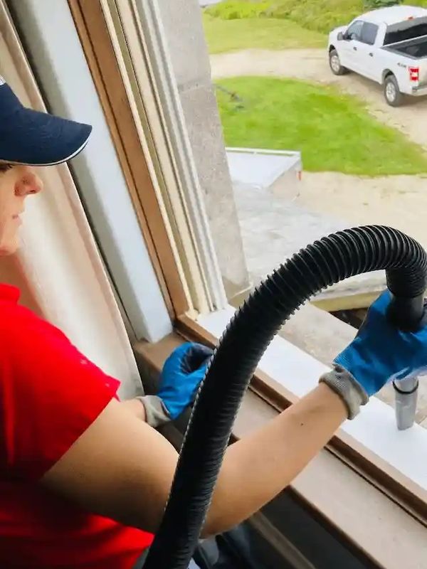 image of technician cleaning window tracks.