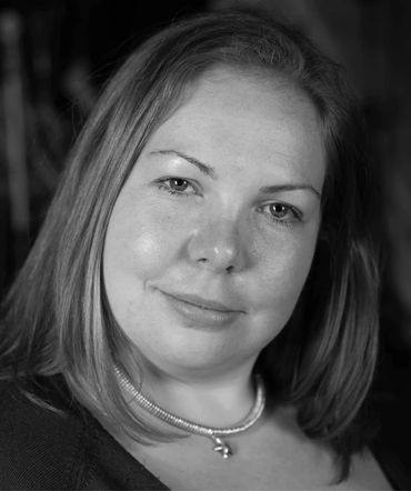 Black and white portrait of a woman with a calm expression.