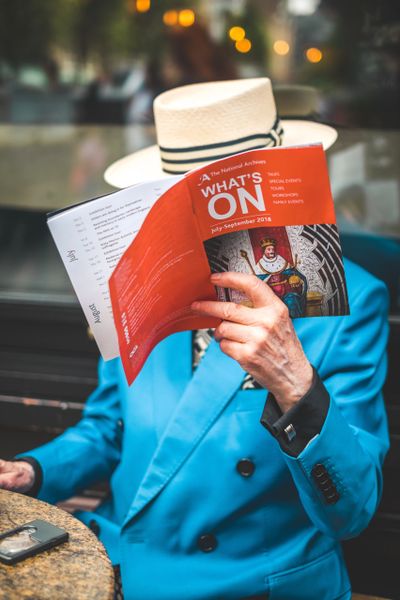 man looking at magazine
