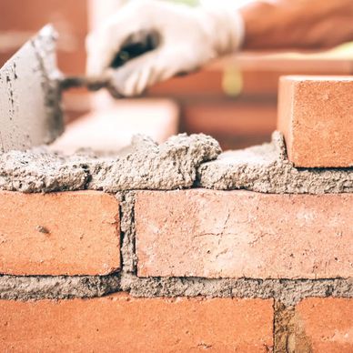 Repair of the brick wall with a mortar spade in use. 