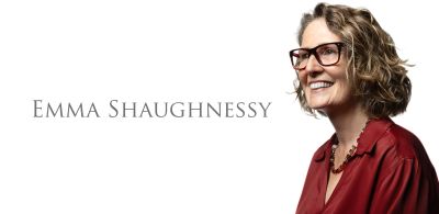 Portrait of Emma Shaughnessy in glasses and red blouse.