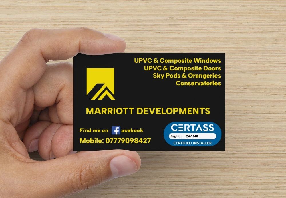 Stack of books next to pencils in a holder and a camera.