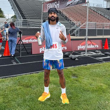 Runner posing after finishing a race at a track event.