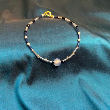 Sheliak star anklet on a blue background