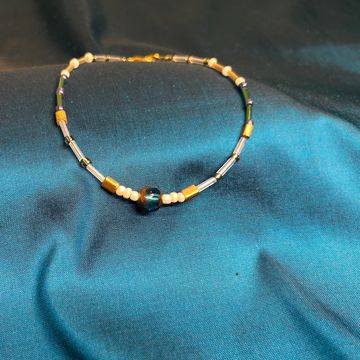 Xihe Star anklet on a blue background