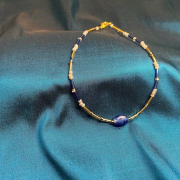 Aladfar Star anklet on a blue background