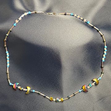 Celaeno Star necklace on a blue background 