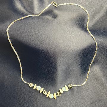 Maia Star necklace on a blue background