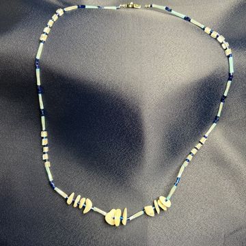 Alcyone Star necklace on a blue background