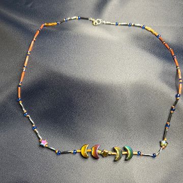 Electra necklace on a blue background 