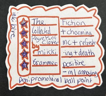 Handwritten note with stars, phrases, and titles in orange and purple ink.