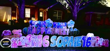 Colorful illuminated birthday yard sign celebrating Sophie's sweet 16.