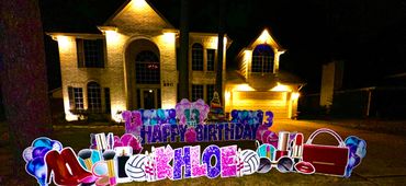 Outdoor nighttime birthday display with "Khloe" and beauty-themed decorations.
