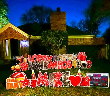 Yard sign celebrating Mike's 40th birthday on game day at night.