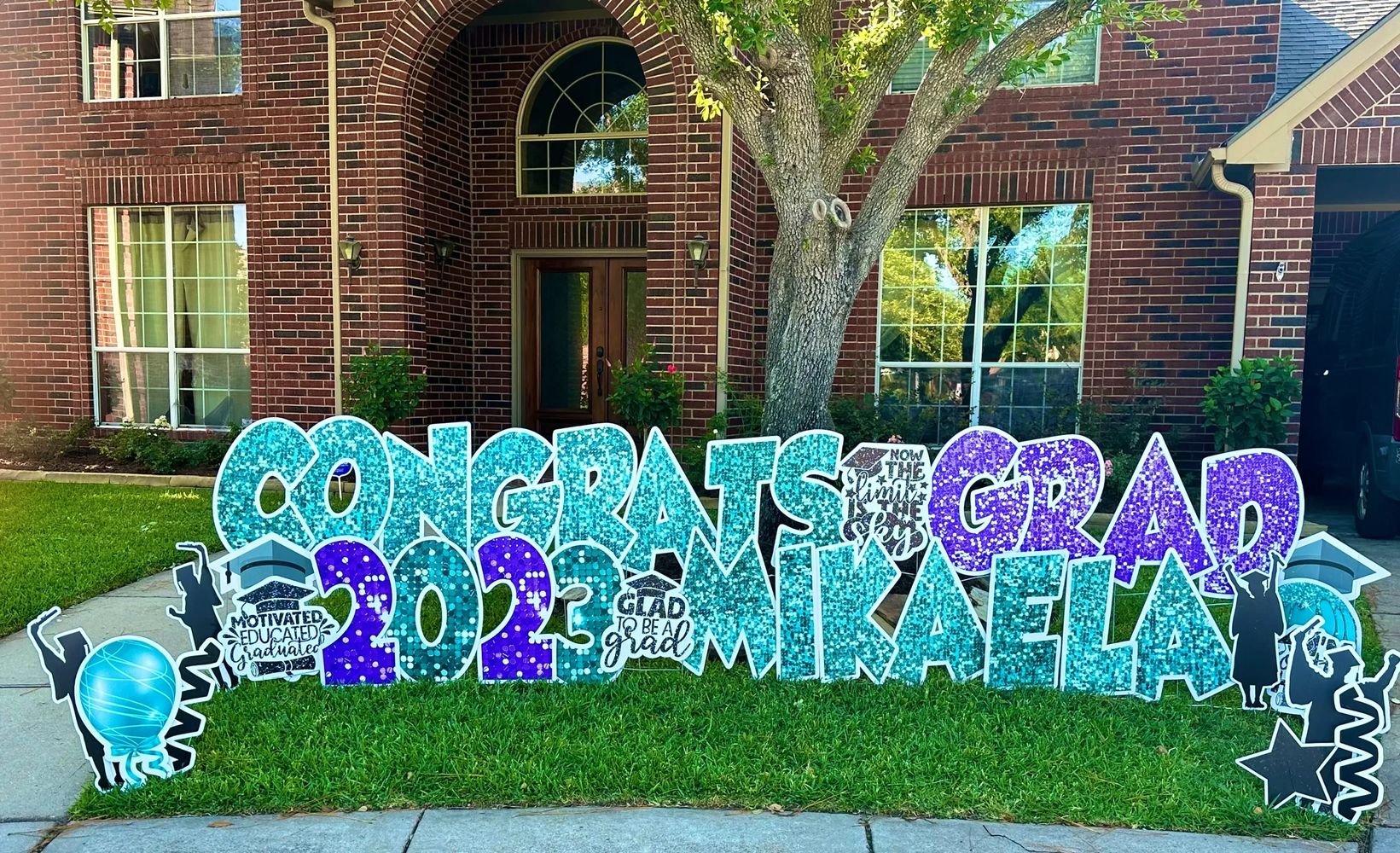 Stack of books next to pencils in a holder and a camera.