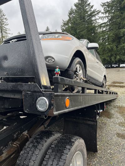 A tow truck away a scrap vehicle in the White Rock community, with our free junk car pickup service