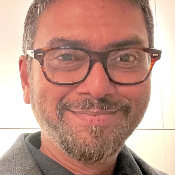 Smiling man with glasses and beard.
