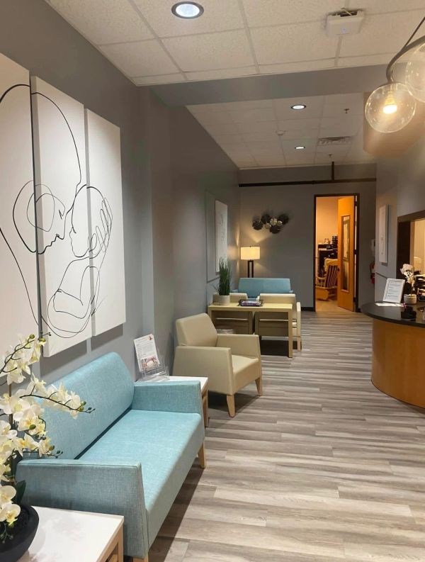 Modern waiting room with light blue and beige seating.